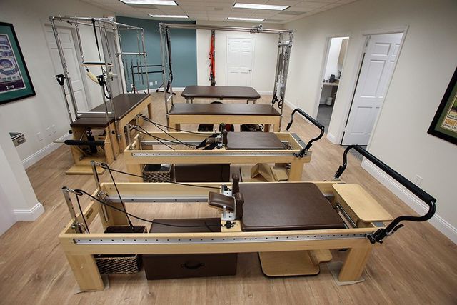 A room with a lot of pilates equipment in it