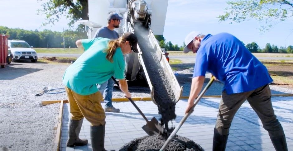 Three concrete contractors working on a construction site