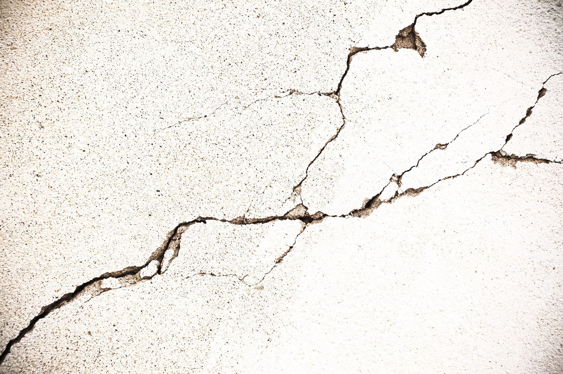 A photo of a concrete surface with visible cracks.