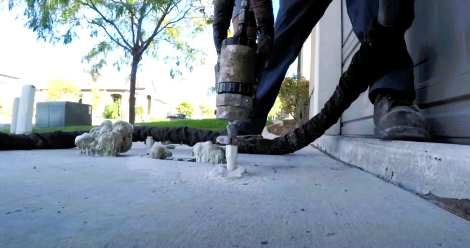 Concrete leveling process being applied on a residential driveway