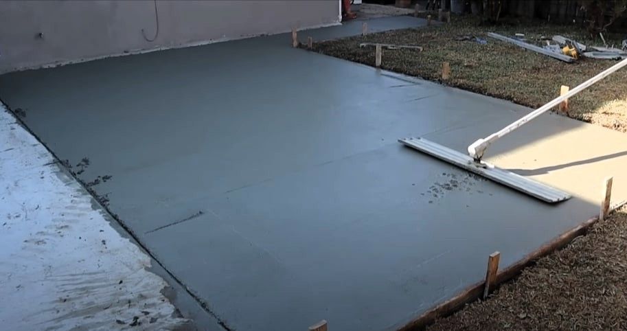 Worker smoothing concrete patio in Grand Rapids
