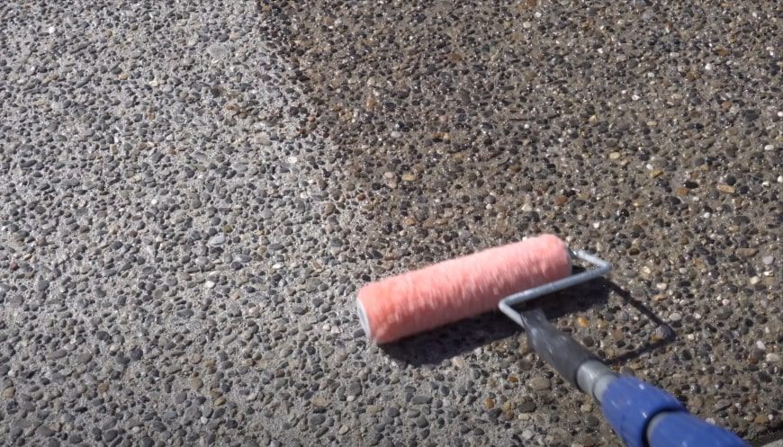 Sealing exposed aggregated concrete with a roller