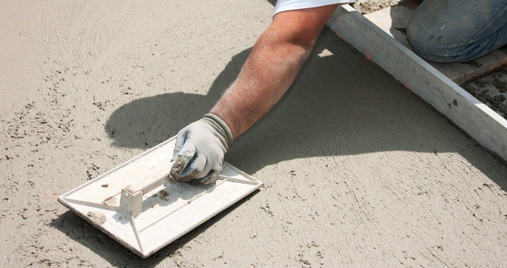 contractor smoothing concrete with a tool