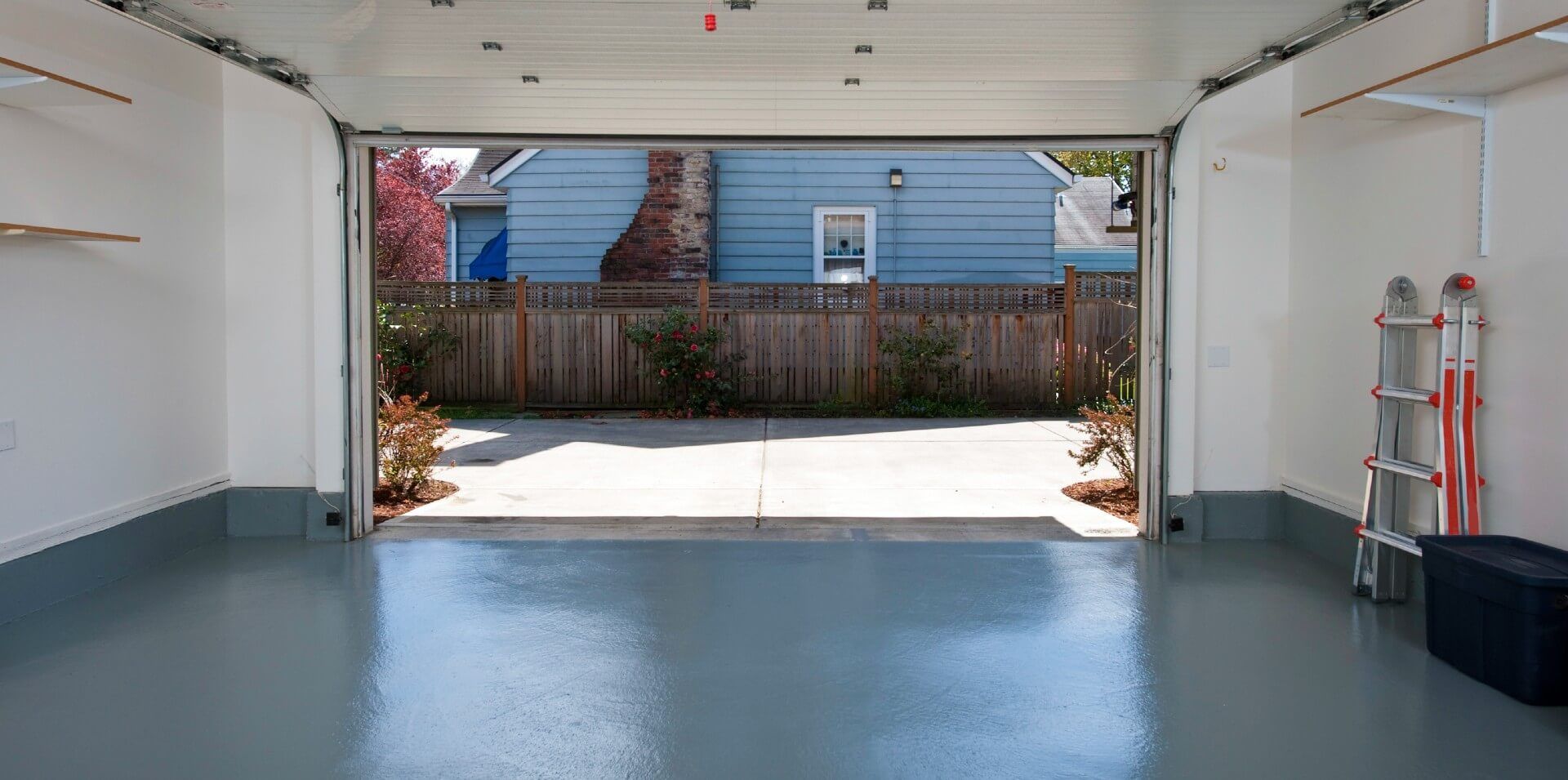 A clean and refreshed-looking garage with concrete epoxy