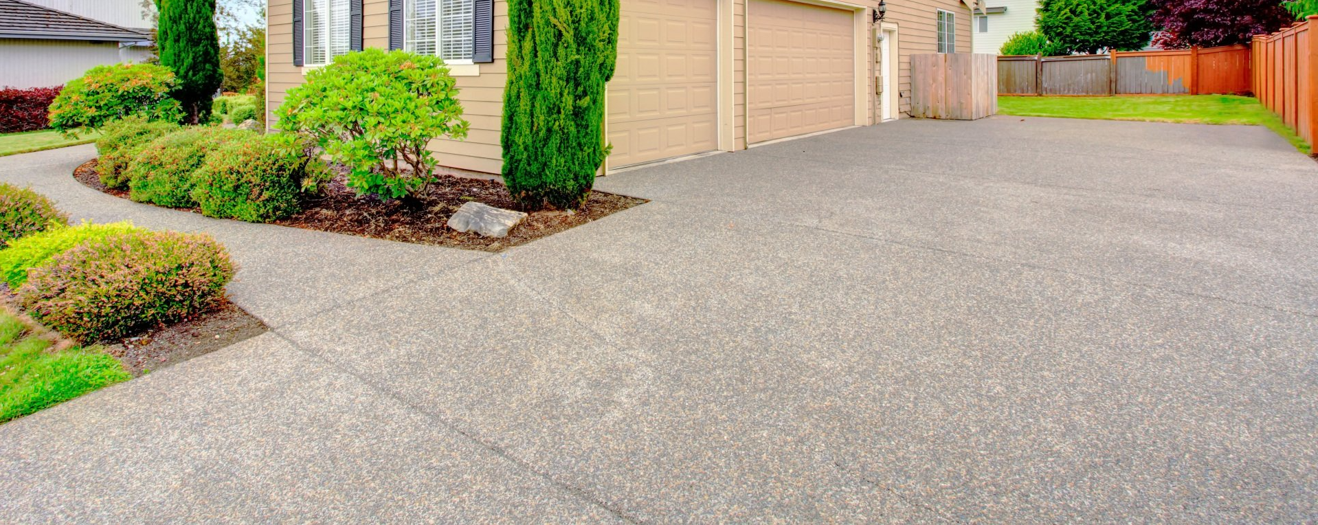 beautiful new aggregate concrete driveway at residential Michigan home