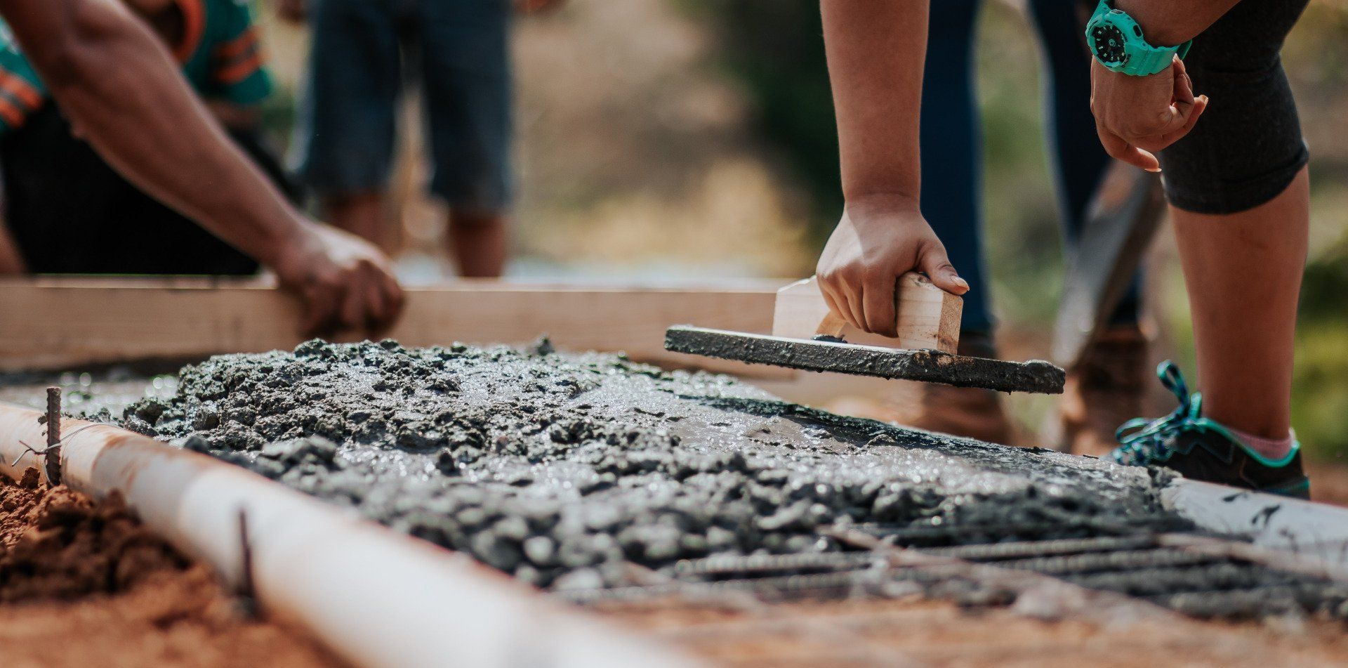 concrete workers forming a cement pad