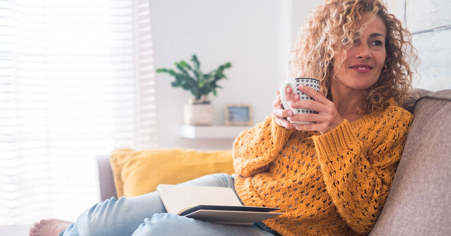 Family eating together in a restaurant; mother feeding daughter, father at table.