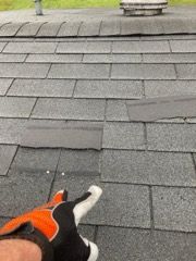 missing shingles and exposed roofing nails