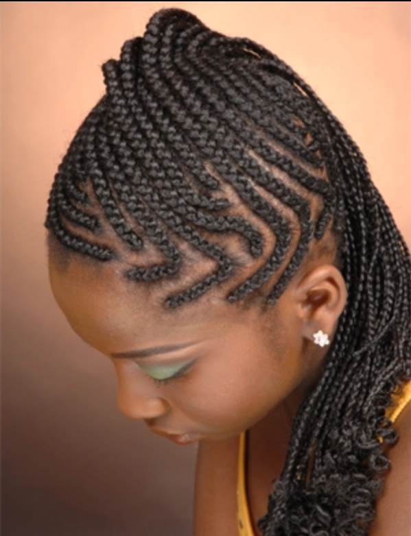 A woman with braids on her head wearing earrings