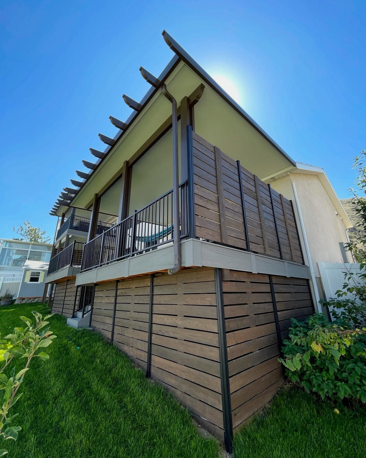 A house with a large deck and a wooden fence