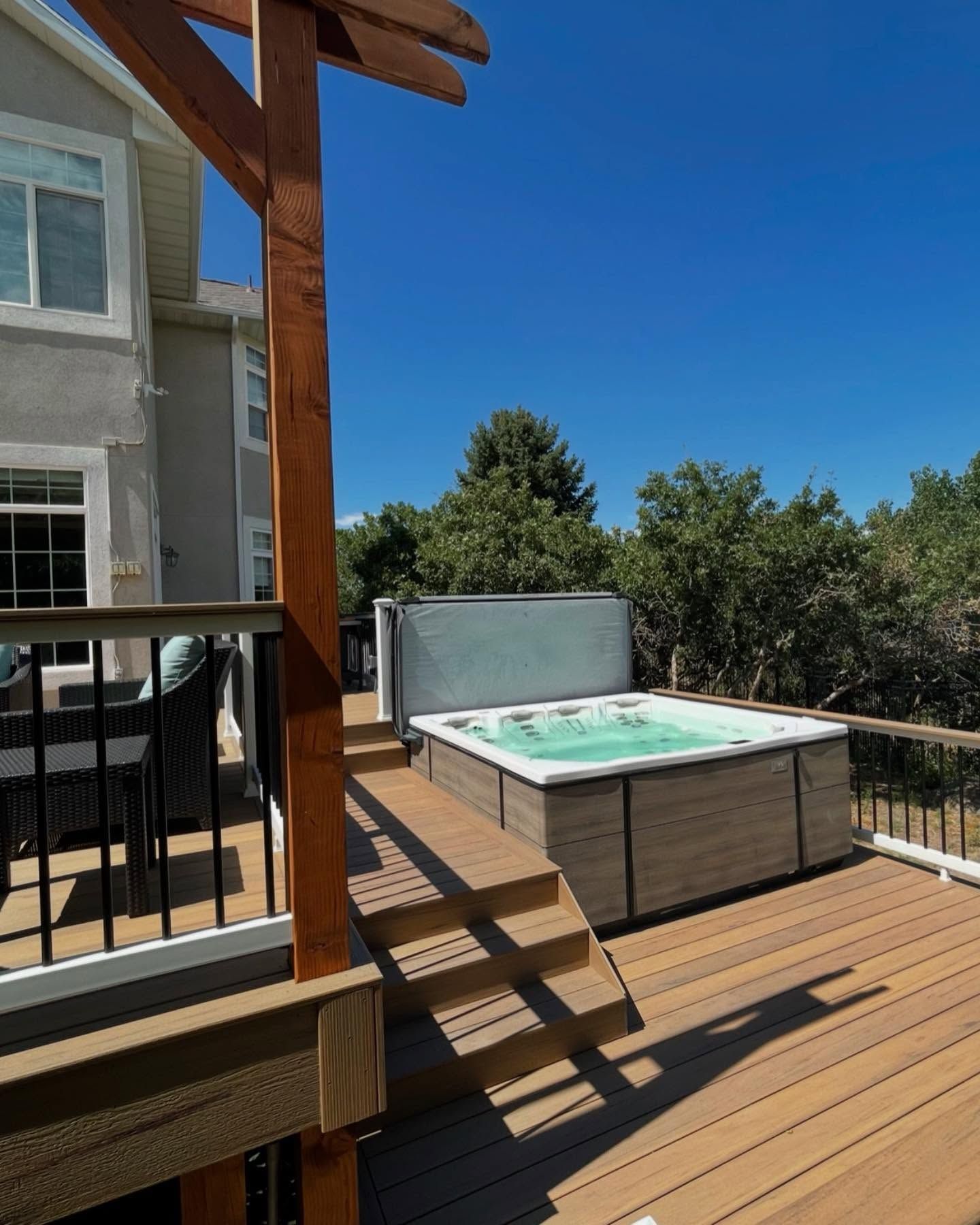 A wooden deck with a hot tub on it