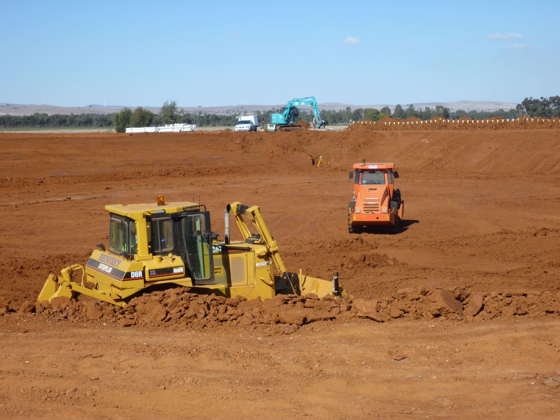A yellow cat bulldozer is working in a dirt field | Murray Bridge, SA | Ridleys SA