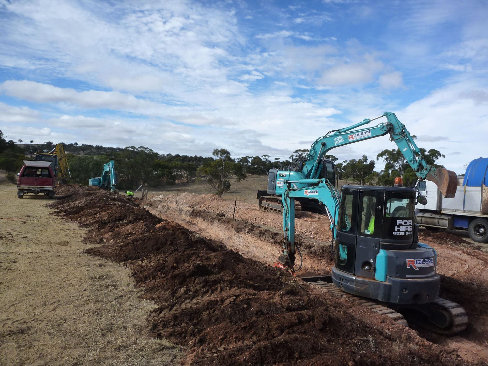 A kobelco excavator is digging a hole in the dirt | Murray Bridge, SA | Ridleys SA