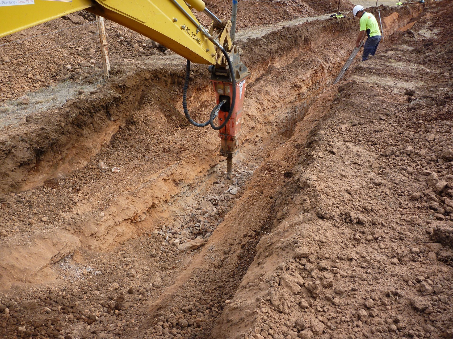 A yellow excavator with a hammer attached to it | Murray Bridge, SA | Ridleys SA