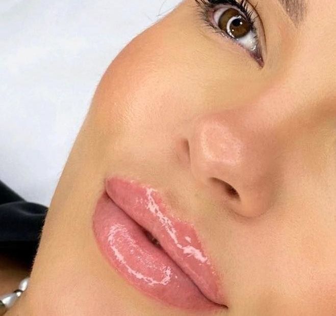 A close up of a woman 's face with pink lips and brown eyes — Sibina Cosmetic Tattoo Art In Broadbeach, QLD