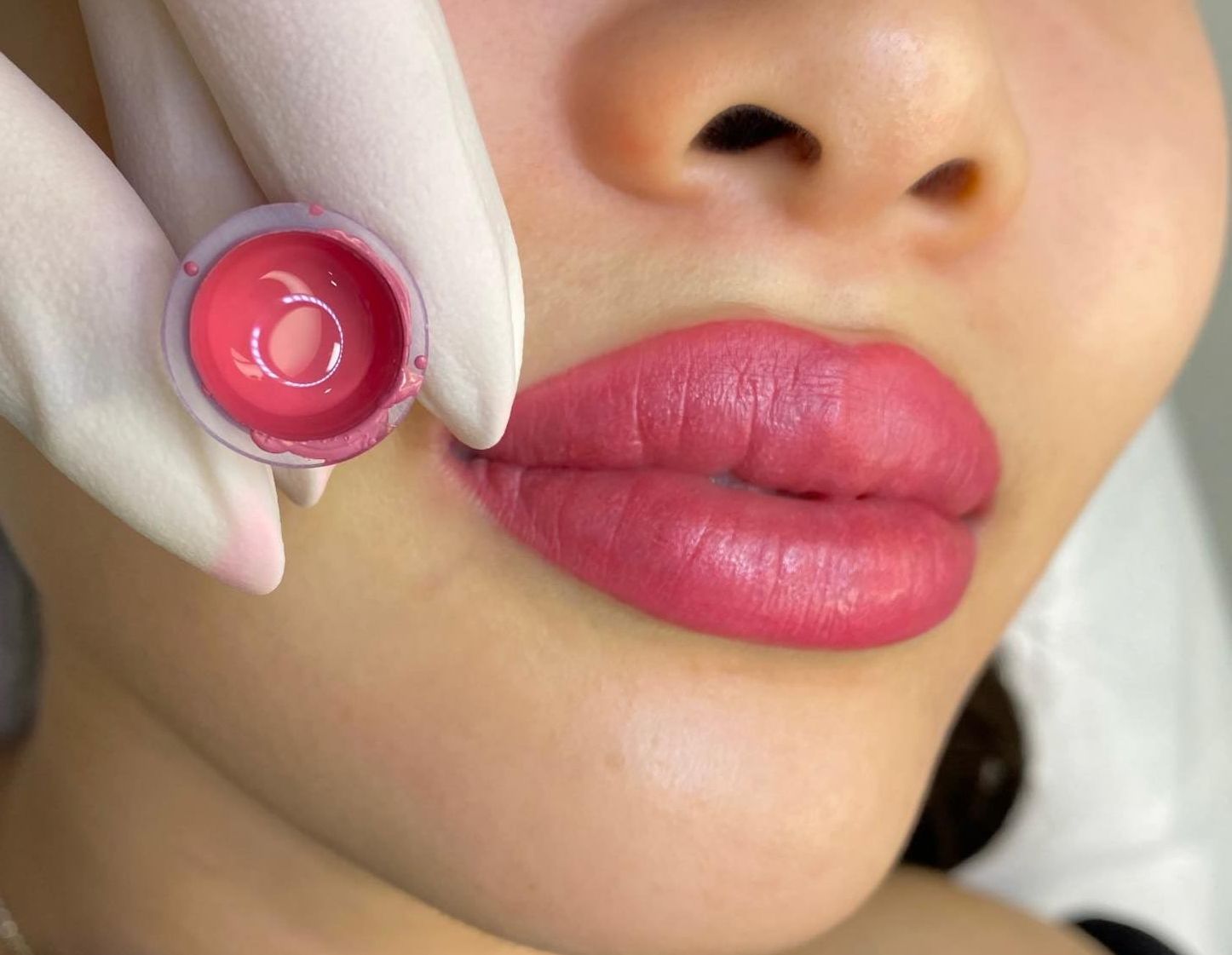 A close up of a woman 's lips being tattooed with pink lipstick — Sibina Cosmetic Tattoo Art In Broadbeach, QLD