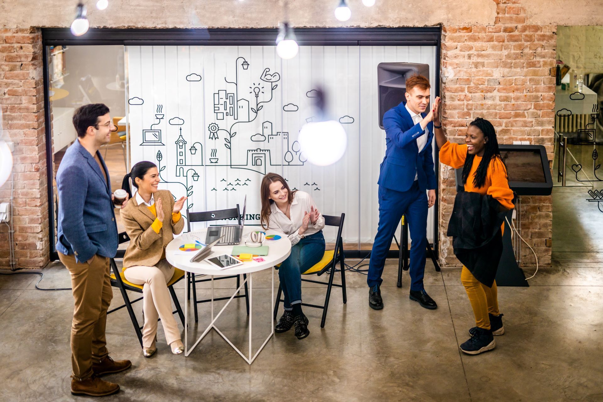 A group of people are standing around a table in a room.