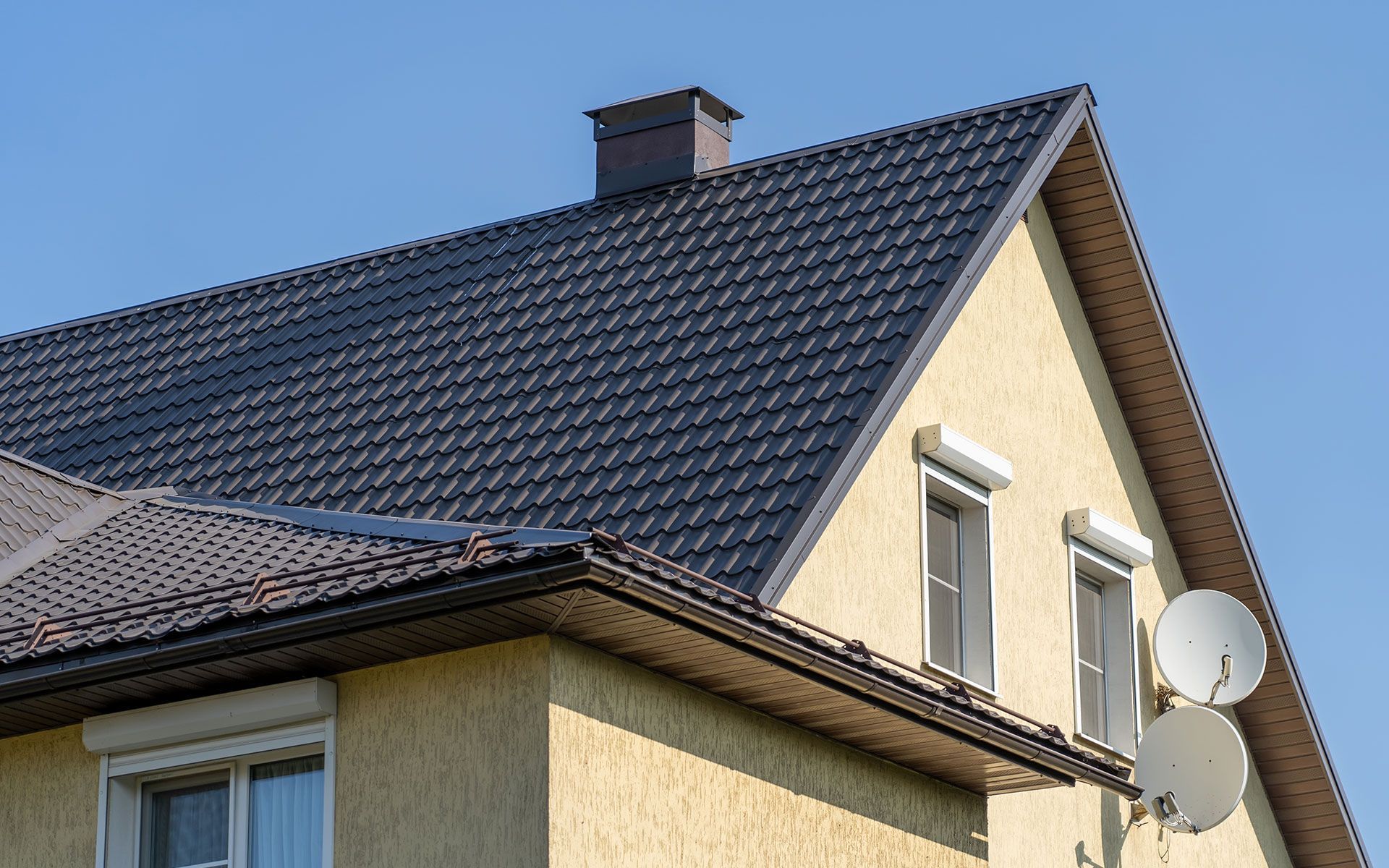 A house with a satellite dish on the side of it.