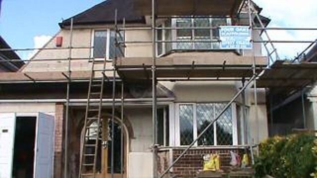 before - scaffolding on the house with bad walls