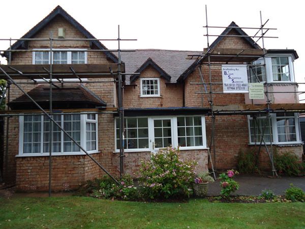before - metal scaffolding on the house