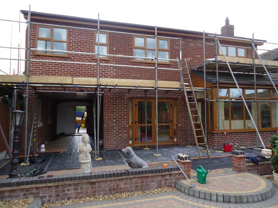 before - metal scaffolding on the house with red brick walls