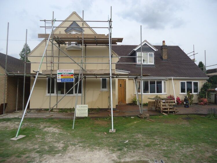 after - rendered house with scaffolding on it