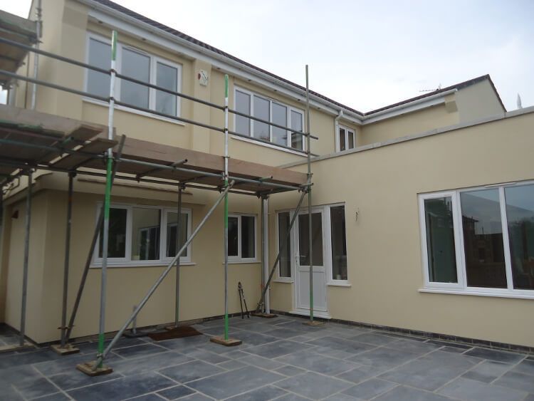 after - rendered house with scaffolding - corner view