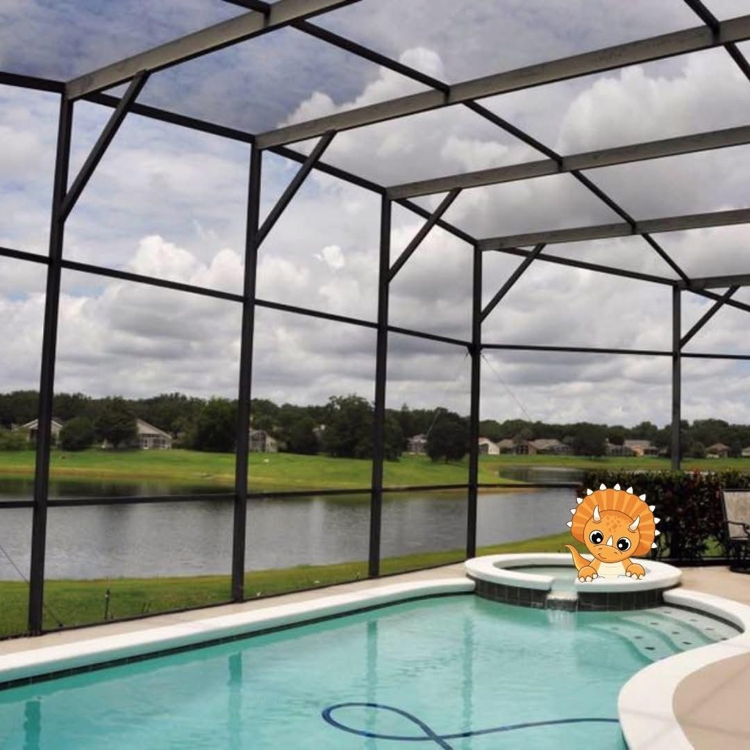 A screened in swimming pool with a triceratops on the edge