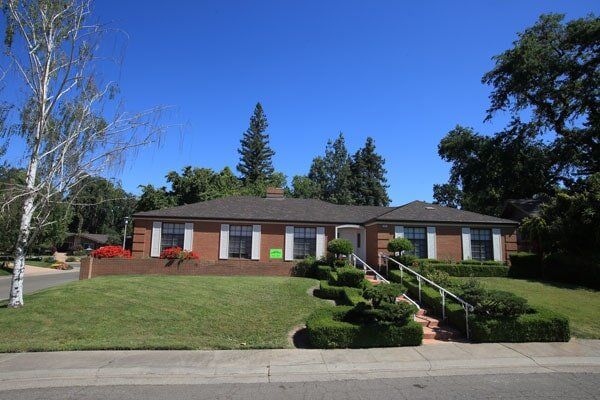 Roofing Supplies — Brown House with White Window and Gray Roofing in Sacramento, CA