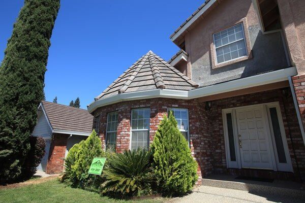 Residential Roofing Information — Two Storey Brown House Front View in Sacramento, CA