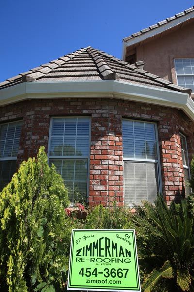 Roofing Materials — Brown House with Company Logo Front View in Sacramento, CA