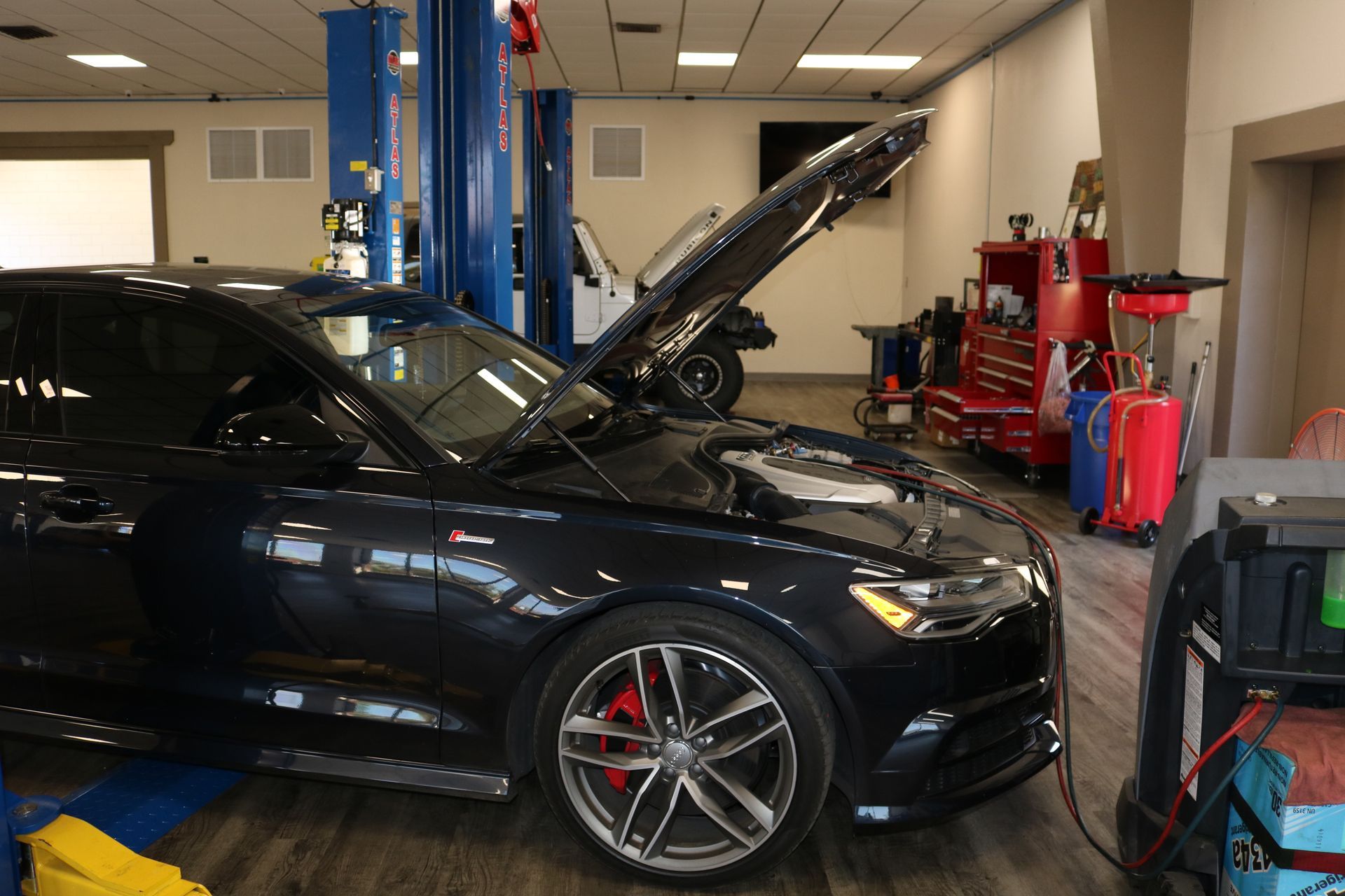 Black Car Inside of Auto Shop | Pensacola AC & Auto Service Center