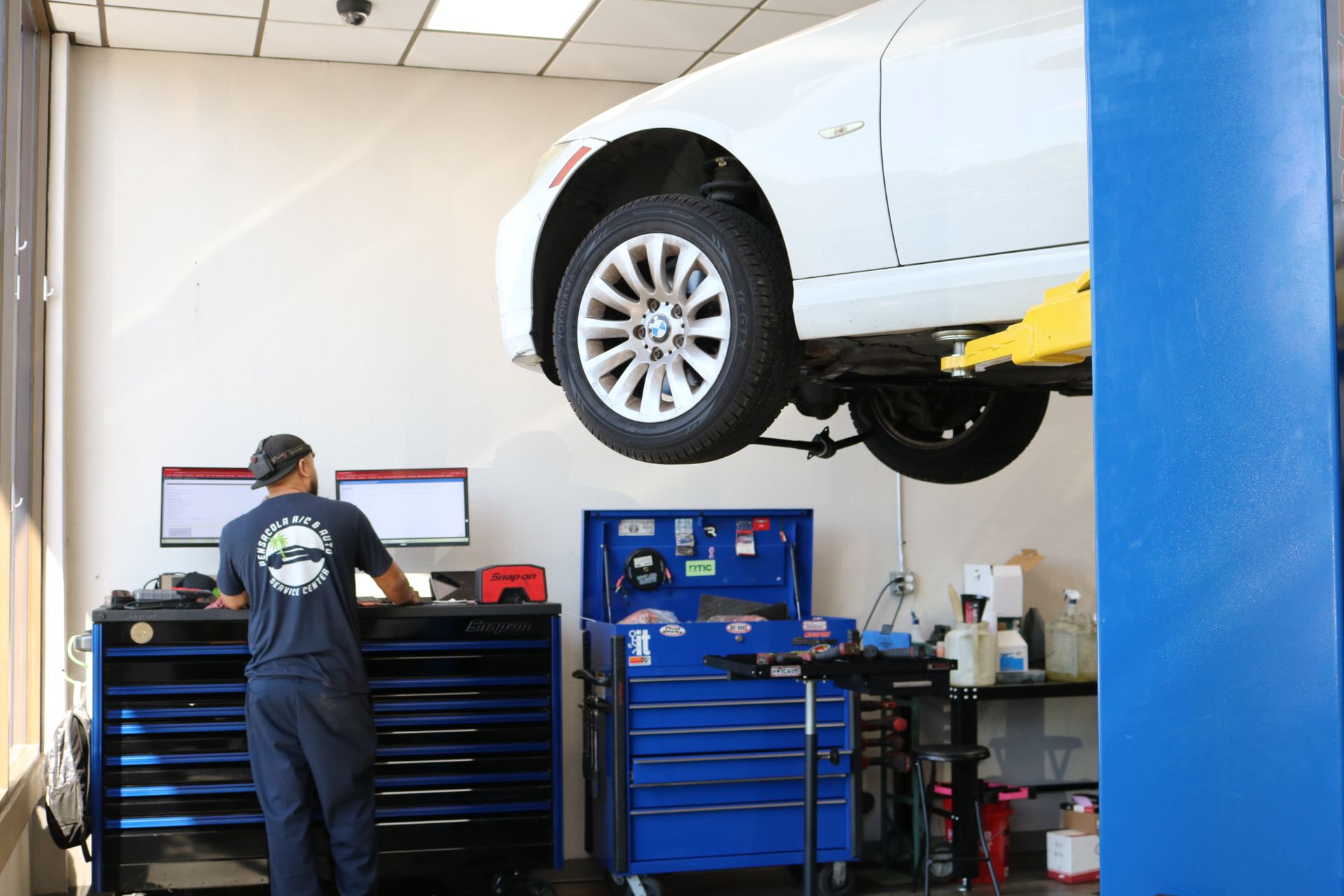 Mechanic Leaning into Tool Cabinet | Pensacola AC & Auto Service Center