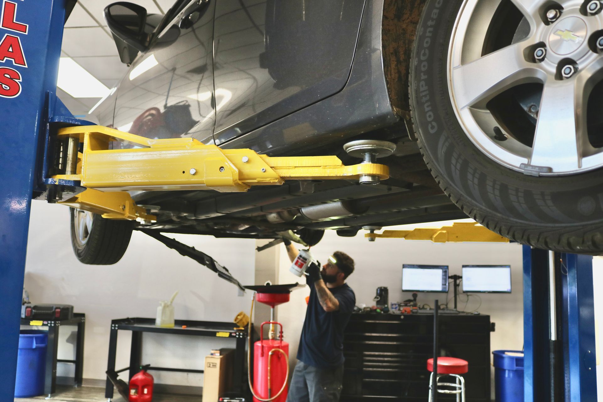 Car Propped Up with Jack | Pensacola AC & Auto Service Center