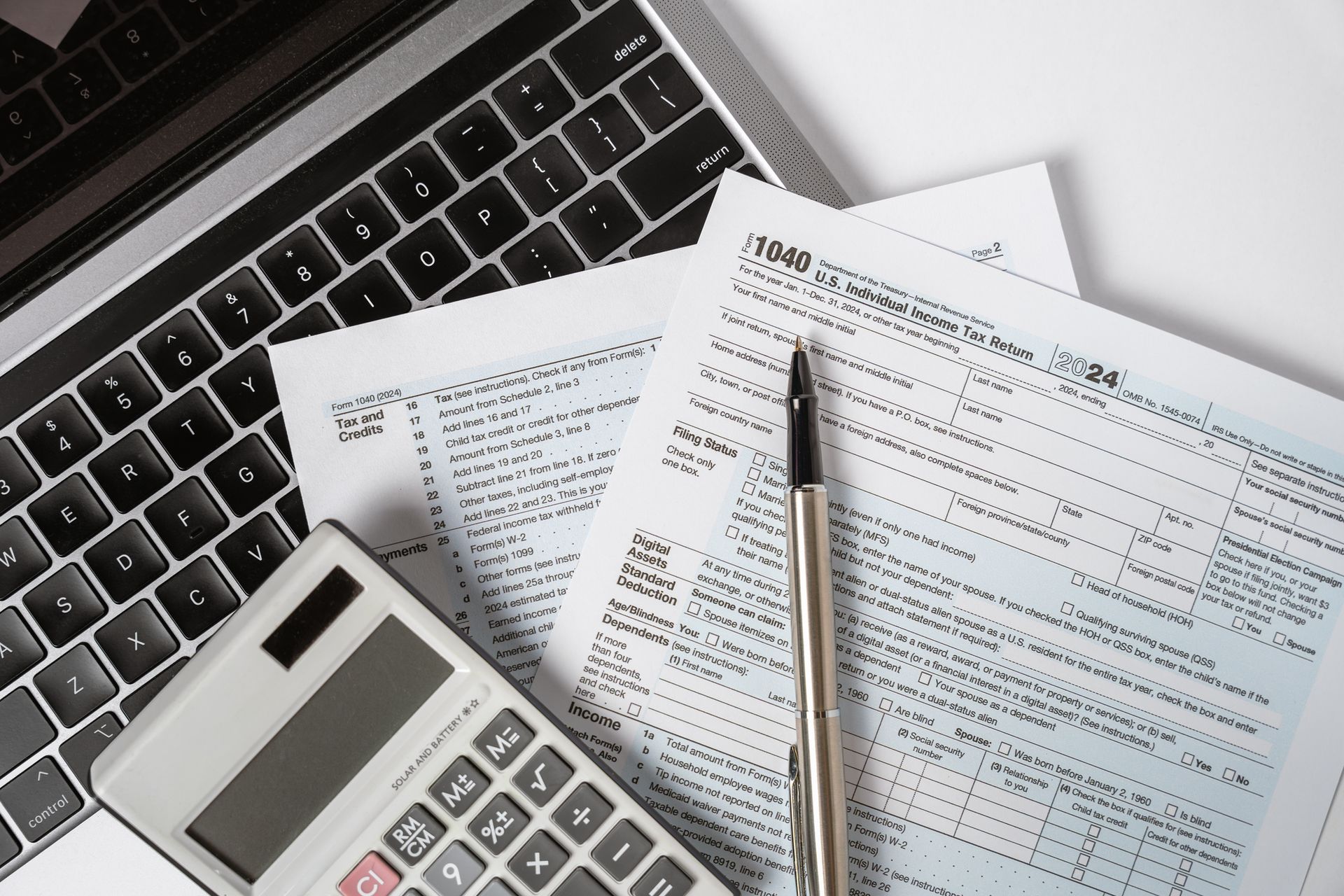 1040 Tax Form with Laptop and Calculator