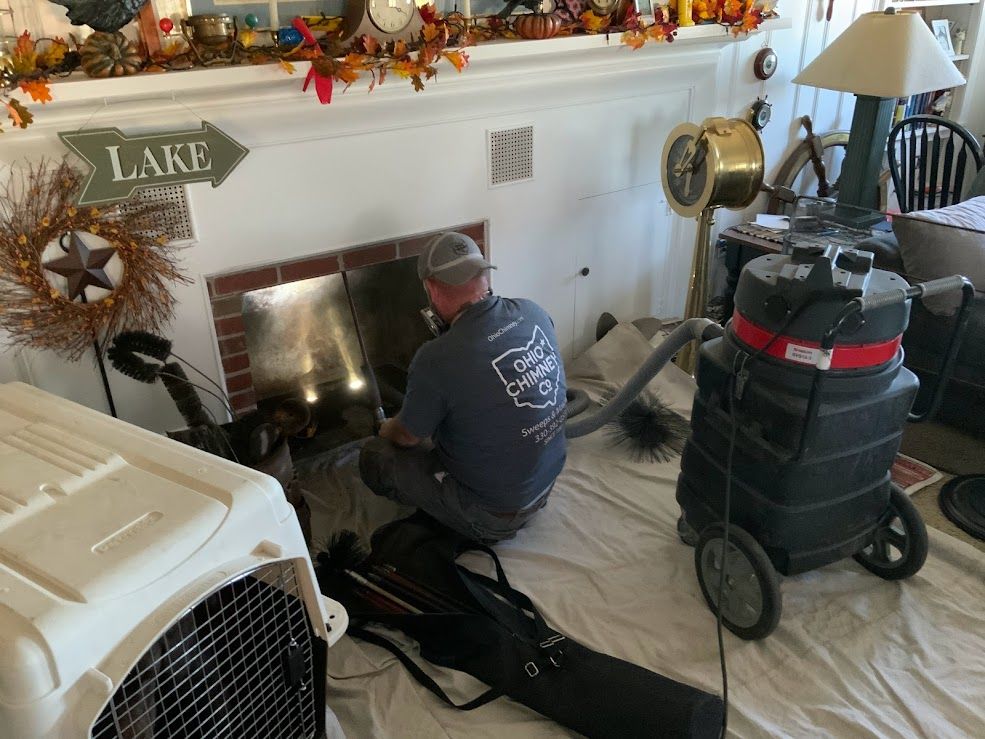 A man is standing on top of a chimney on a roof.