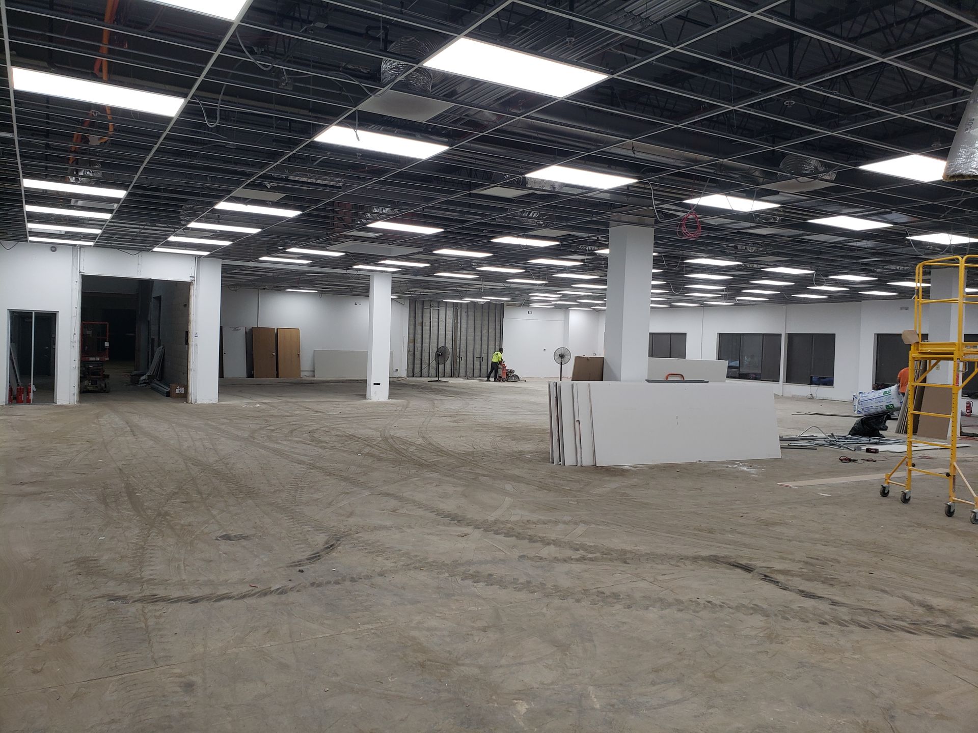 A large empty building with a lot of lights on the ceiling.