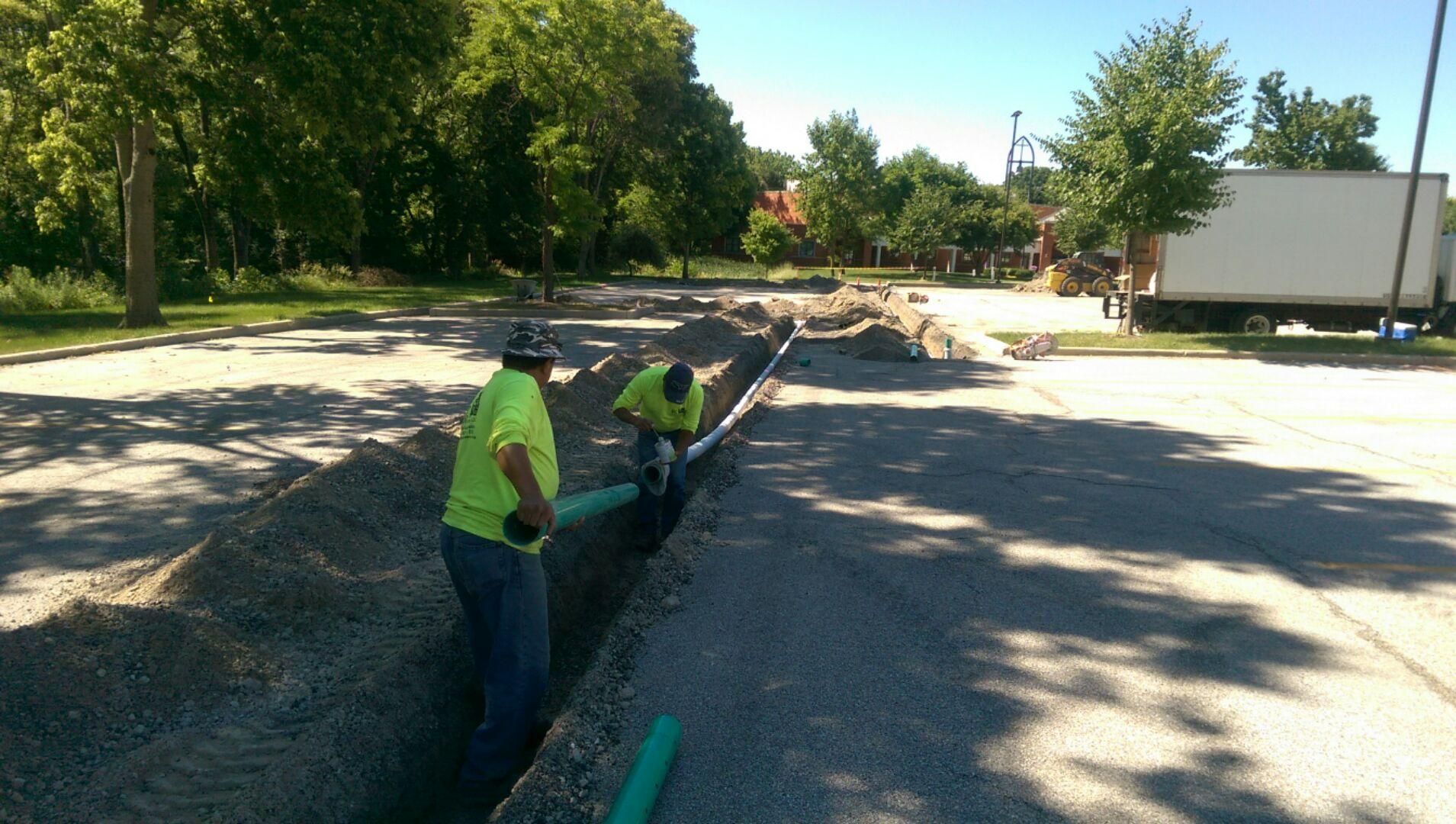 Two Men Installing Drain | Elgin, IL | RG Asphalt & Concrete LLC