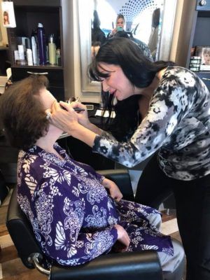 Woman Doing a Makeup to Customer — Scottsdale, AZ — XanderLyn Salon