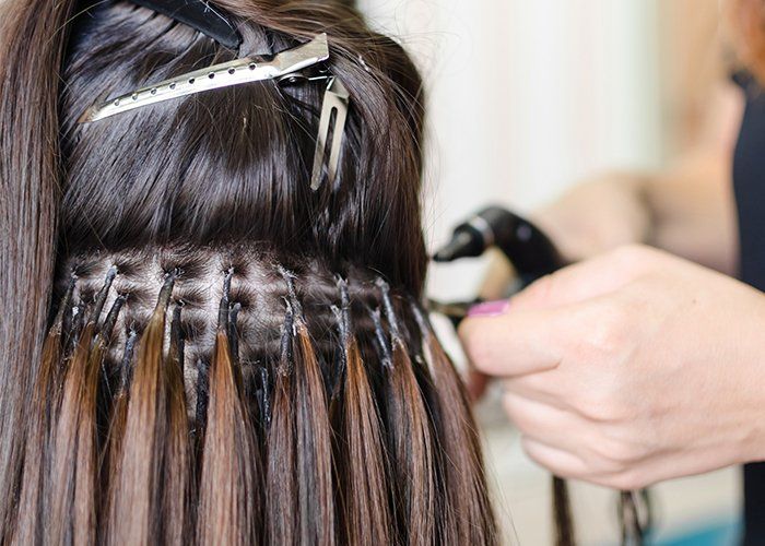 Hair Dresser Appointment — Hairdresser Does Hair Extensions to a Red-haired Girl in Scottsdale, AZ