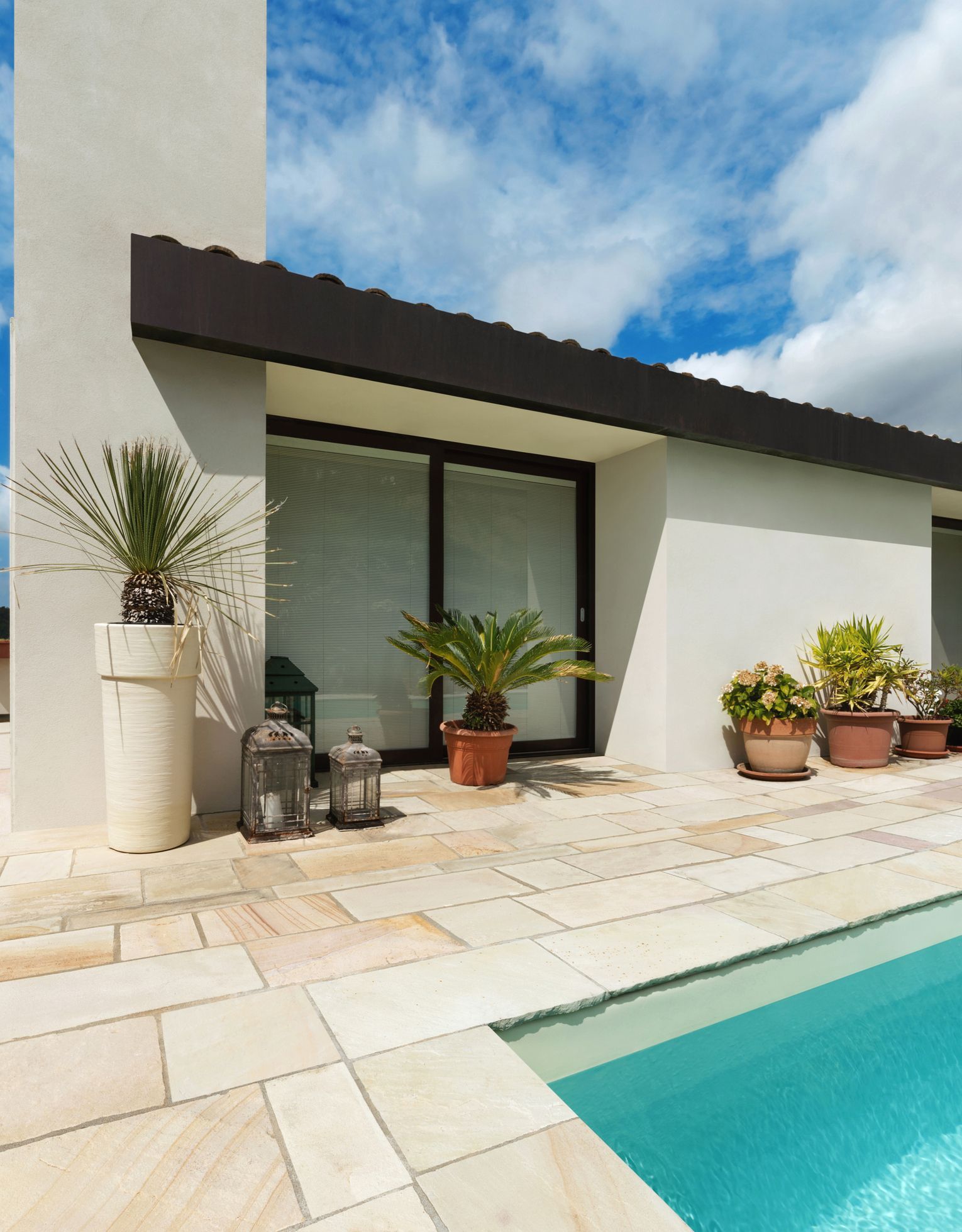 A house with a swimming pool in front of it