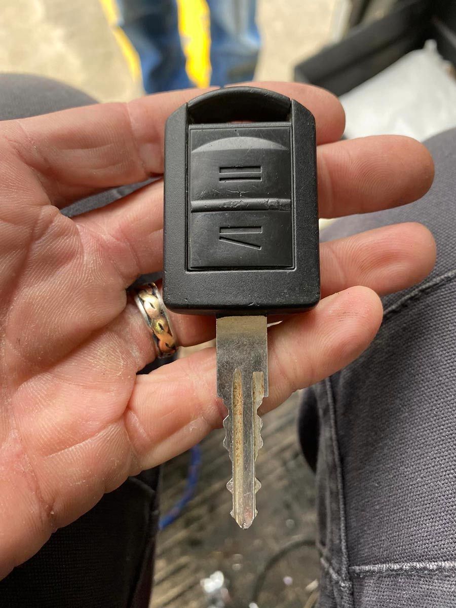 A Person Is Holding A Car Key In Their Hand — ClarKEYS Mobile Locksmiths In Winter Valley, VIC