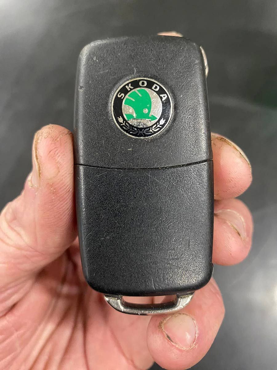 A Person Is Holding A Skoda Car Key In Their Hand — ClarKEYS Mobile Locksmiths In Winter Valley, VIC