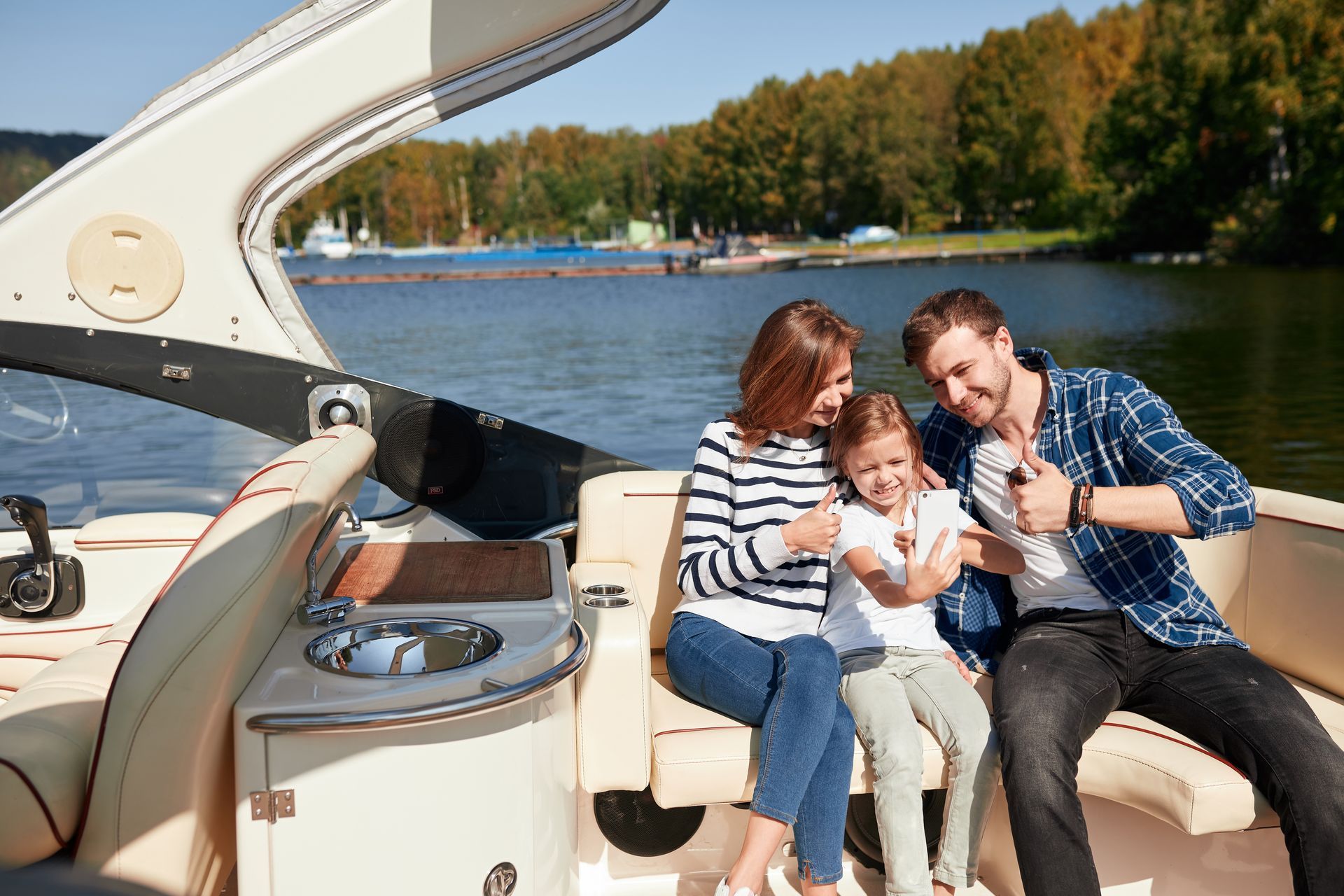 A family is sitting on a boat in the water.