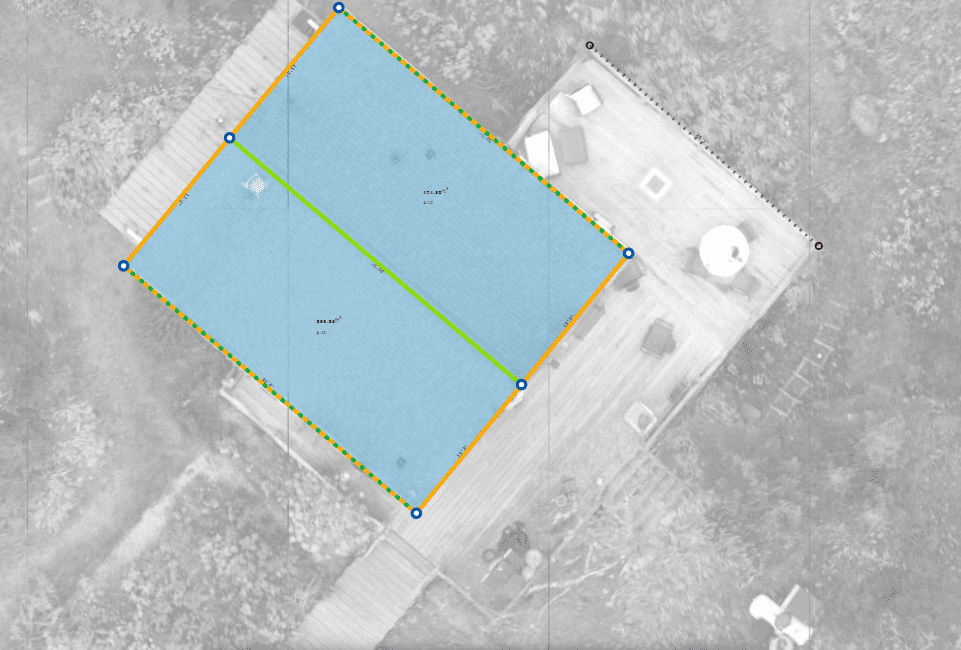 Aerial view of a blue-roofed building on a wooden deck, outlined with a yellow border.