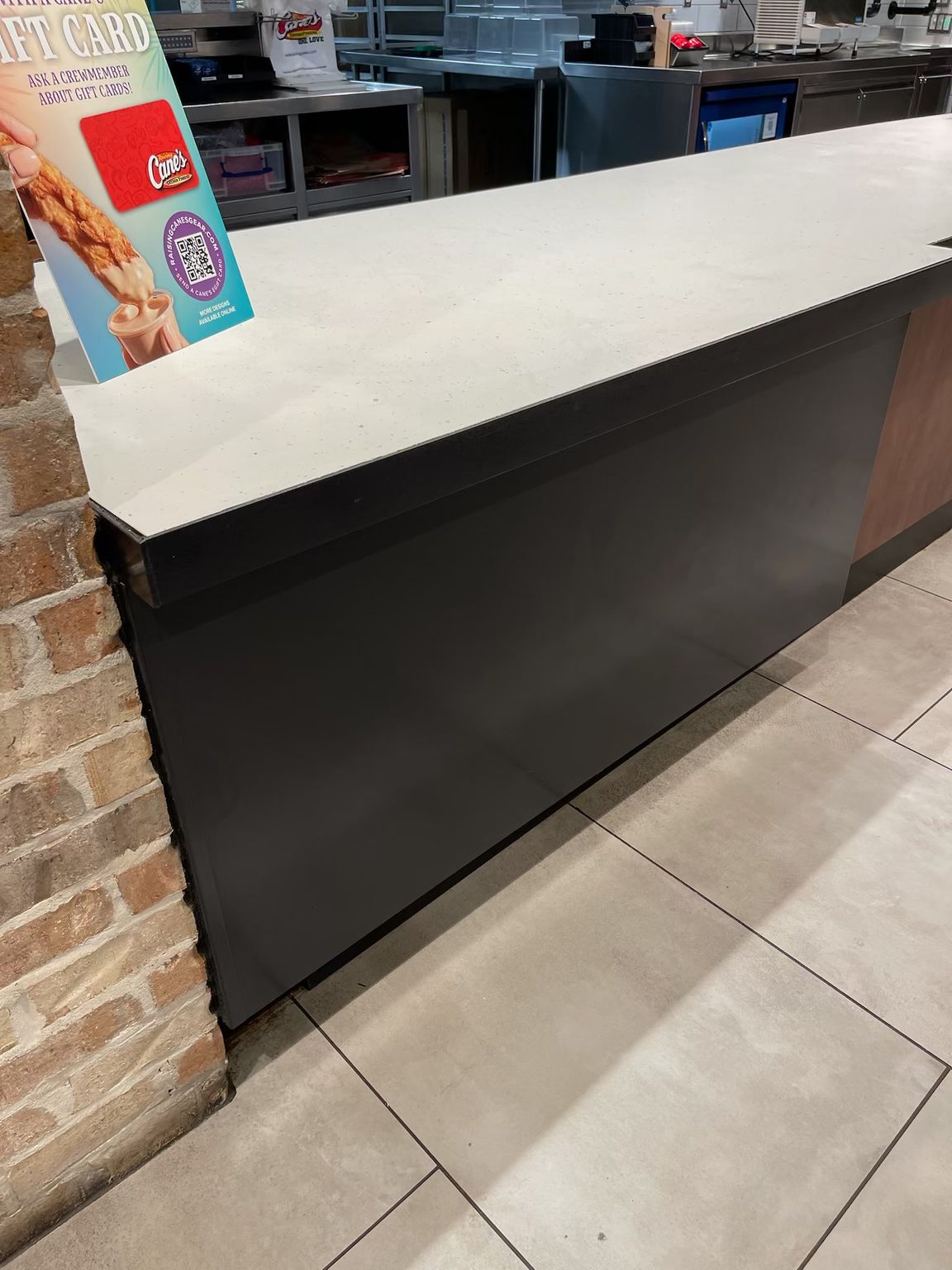 A counter in a restaurant with a sign that says ice cream