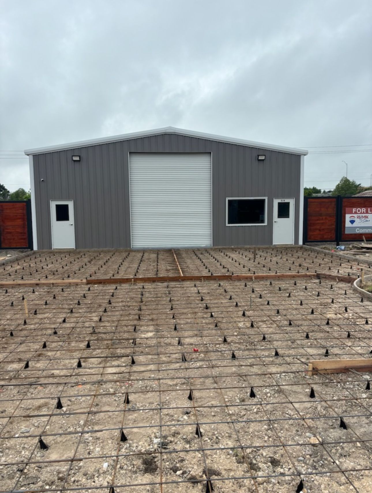 A large building with a large garage door is being built.