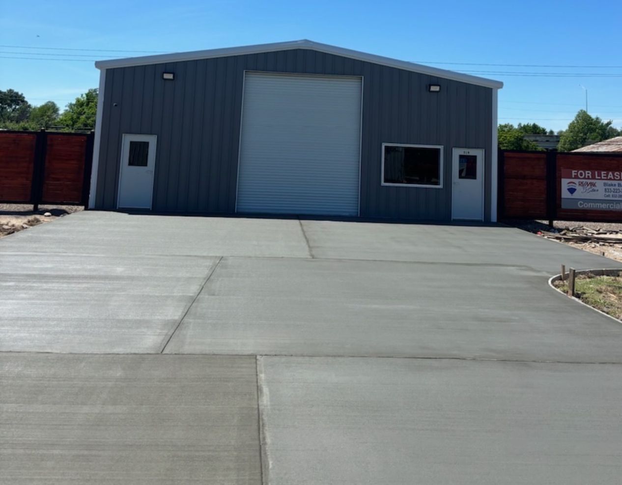 A garage with a concrete driveway leading to it