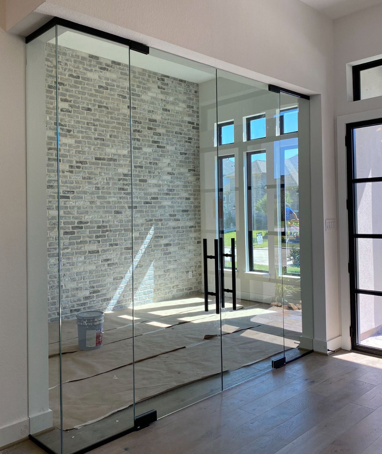 A room with a brick wall and sliding glass doors.