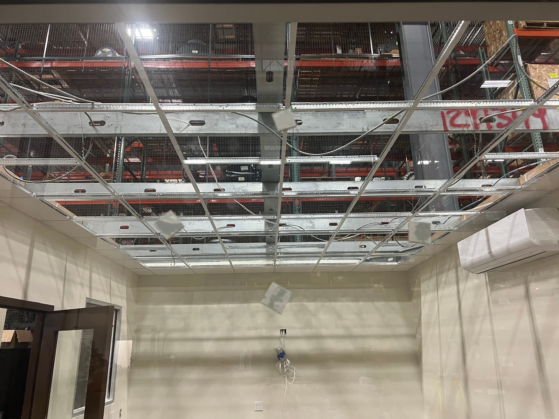 A room with a ceiling that is being remodeled in a warehouse.